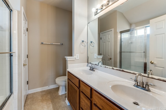 bathroom featuring walk in shower, vanity, tile patterned flooring, and toilet