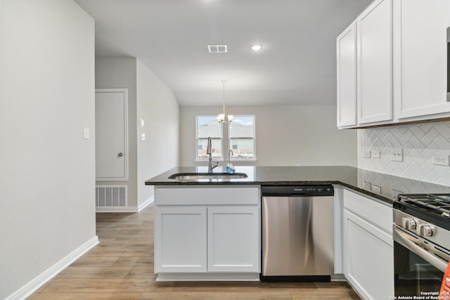 kitchen featuring stainless steel appliances, sink, and white cabinets