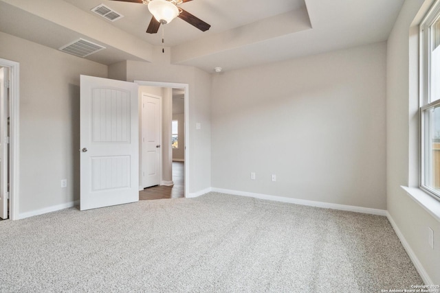 unfurnished bedroom with multiple windows, carpet floors, and ceiling fan