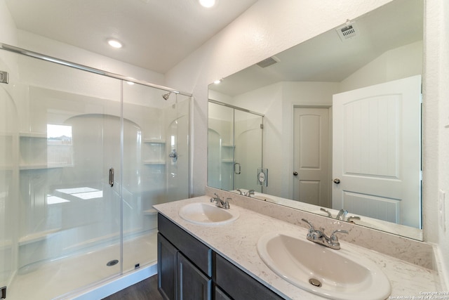 bathroom with a shower with door, hardwood / wood-style flooring, and vanity