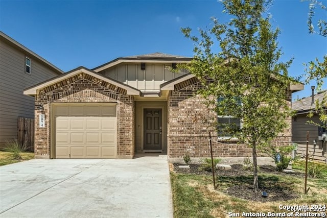 1074 Cozumel Emerald, San Antonio, TX 78253 - view of front of home with brick siding, driveway, board and batten siding, and an attached garage