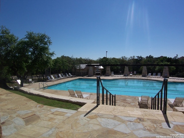 view of swimming pool featuring a patio area