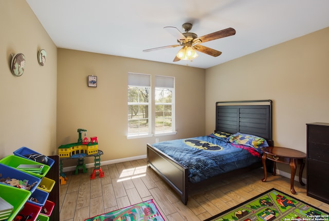 bedroom with ceiling fan and light hardwood / wood-style floors