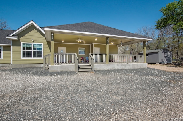 view of front of property with a porch, a storage shed, and ceiling fan