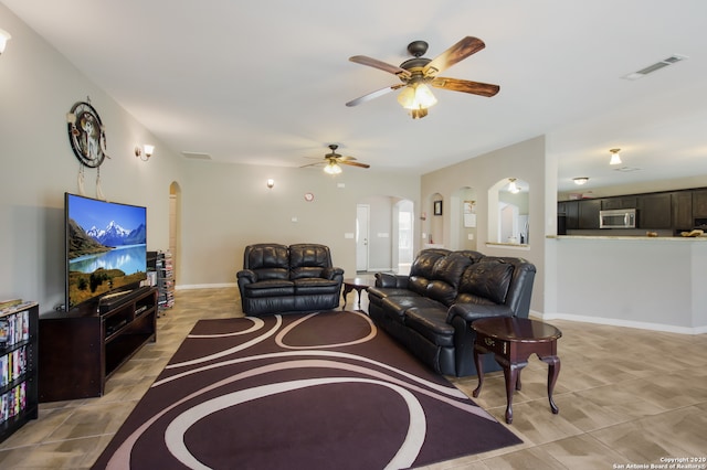 living room with light tile patterned floors and ceiling fan