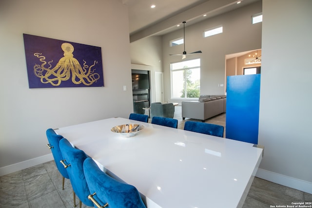 dining area featuring a high ceiling and ceiling fan