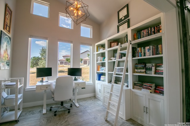 office featuring lofted ceiling, a chandelier, and a wealth of natural light