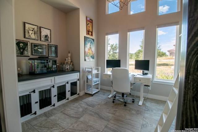 office space featuring a high ceiling and a wealth of natural light