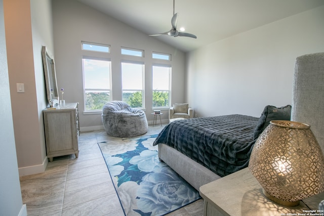 bedroom with lofted ceiling, light tile patterned floors, and ceiling fan