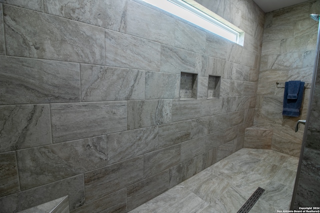 bathroom with tiled shower