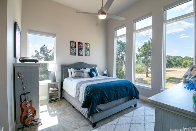 bedroom featuring multiple windows and ceiling fan