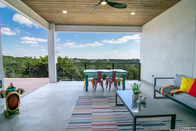 view of patio with ceiling fan and a balcony