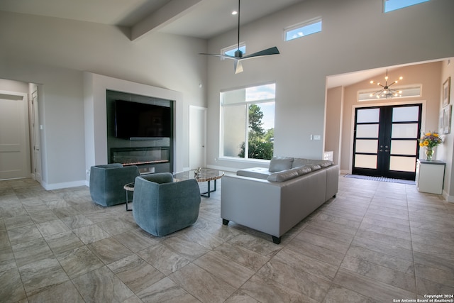 living room with french doors, beamed ceiling, ceiling fan with notable chandelier, and high vaulted ceiling