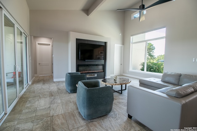 living room featuring high vaulted ceiling, ceiling fan, and beamed ceiling