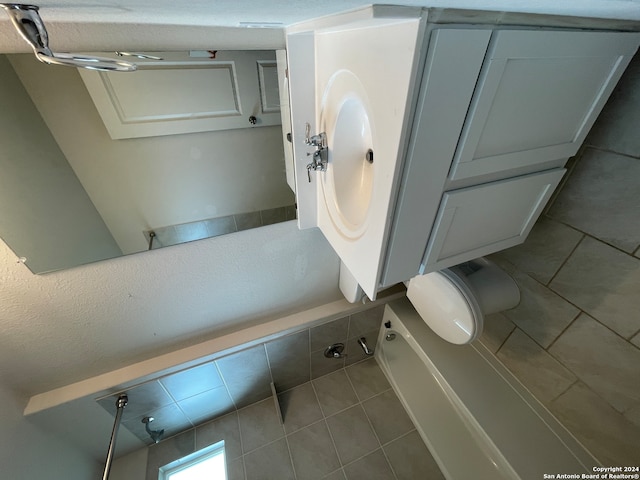 bathroom with tile patterned flooring, vanity, and toilet