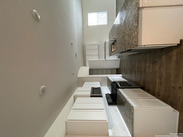 kitchen with tasteful backsplash and white cabinets