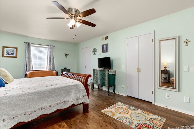 bedroom with ceiling fan and dark hardwood / wood-style flooring