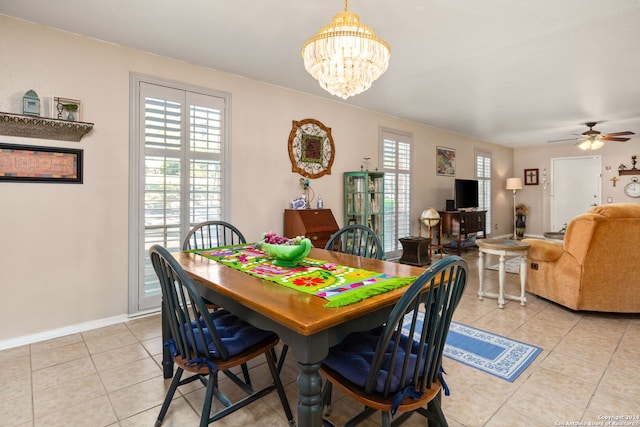 dining space featuring ceiling fan with notable chandelier and light tile patterned floors