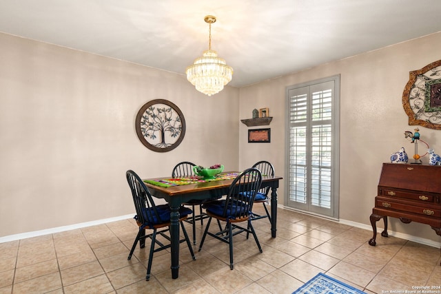 tiled dining room featuring an inviting chandelier