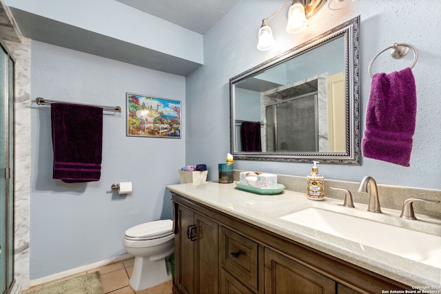 bathroom featuring walk in shower, tile patterned floors, vanity, and toilet