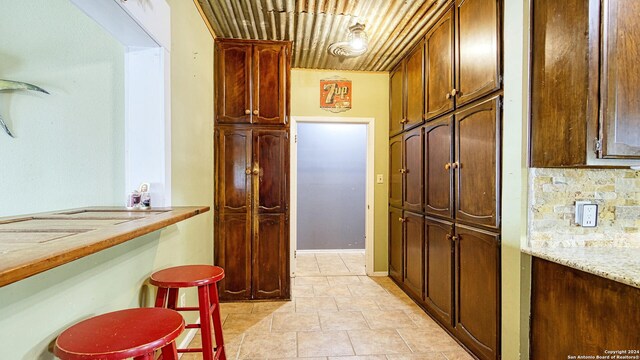 1801 3rd St, Floresville, TX 78114 - corridor with light tile patterned floors and wood ceiling