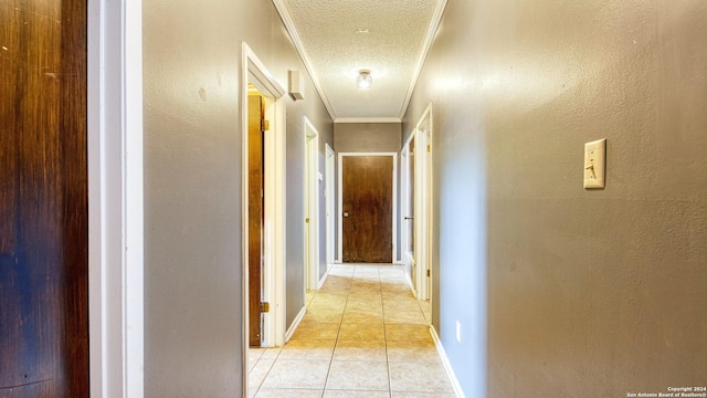 1801 3rd St, Floresville, TX 78114 - hallway with a textured ceiling, light tile patterned flooring, baseboards, and crown molding