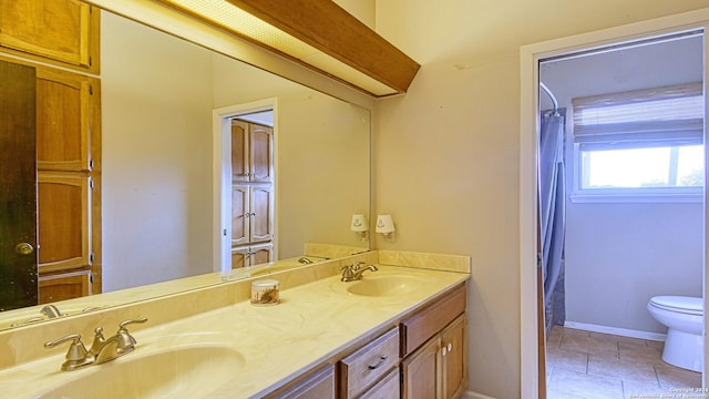 bathroom featuring toilet, vanity, tile patterned floors, and a shower with curtain