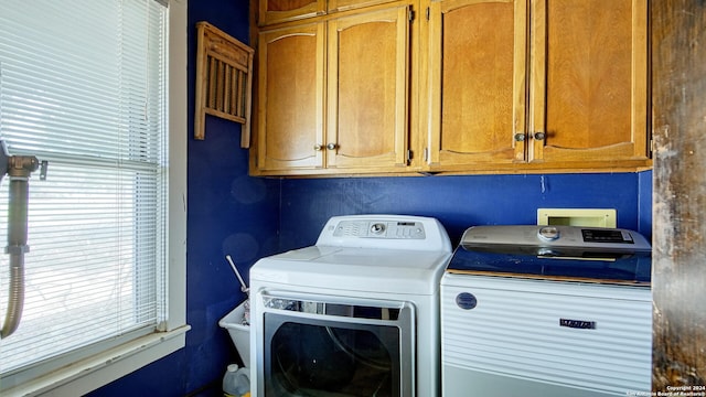 washroom featuring cabinets and washer and dryer