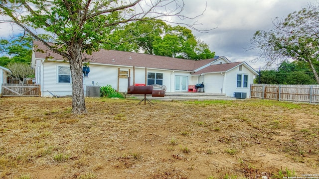 back of property featuring a wooden deck and central AC