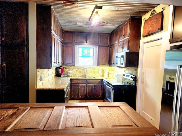 1801 3rd St, Floresville, TX 78114 - kitchen with appliances with stainless steel finishes, a sink, light countertops, and tasteful backsplash