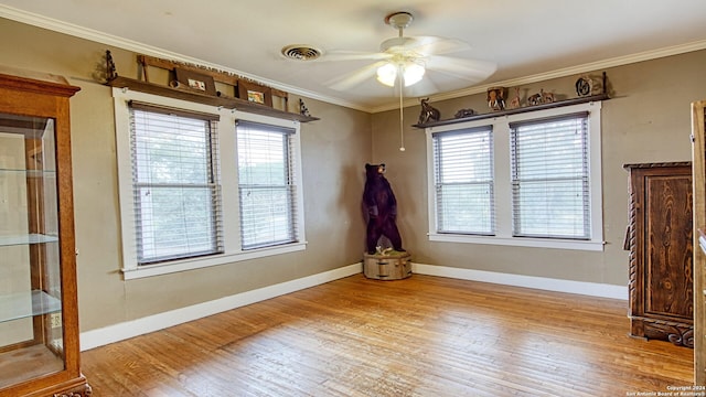 1801 3rd St, Floresville, TX 78114 - spare room with a ceiling fan, wood finished floors, ornamental molding, and baseboards