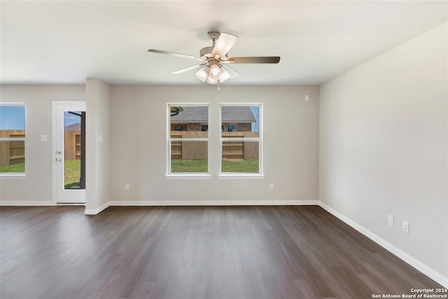 unfurnished room featuring dark wood-type flooring and ceiling fan