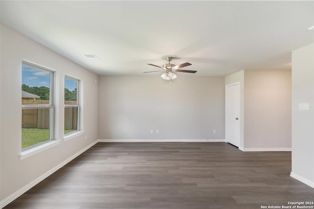 spare room featuring ceiling fan and dark hardwood / wood-style flooring