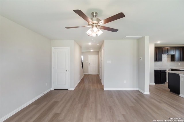 unfurnished living room with ceiling fan and light wood-type flooring