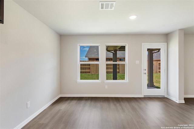 empty room with hardwood / wood-style floors