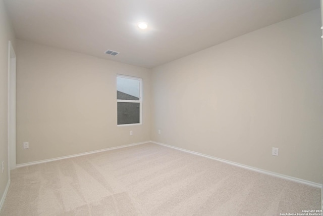 spare room with light carpet