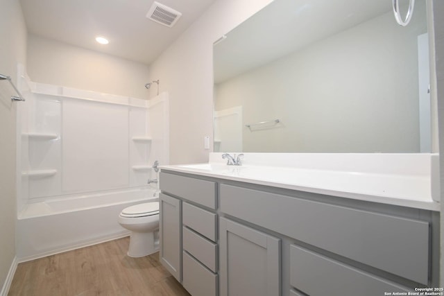 full bathroom with shower / bathtub combination, wood-type flooring, toilet, and vanity