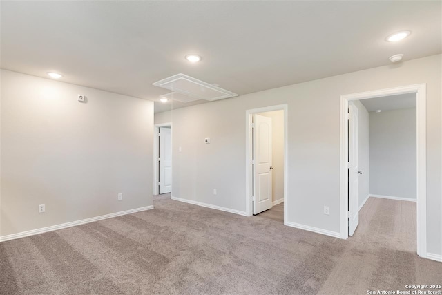 spare room featuring light colored carpet