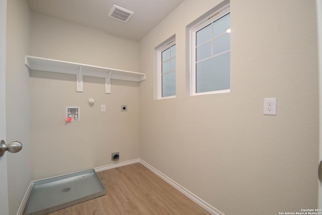 laundry room featuring hookup for a washing machine, gas dryer hookup, electric dryer hookup, and hardwood / wood-style floors