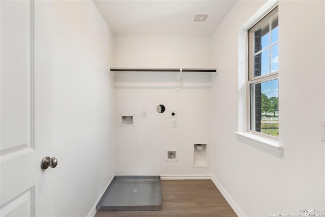 clothes washing area featuring hardwood / wood-style flooring, gas dryer hookup, hookup for a washing machine, and hookup for an electric dryer