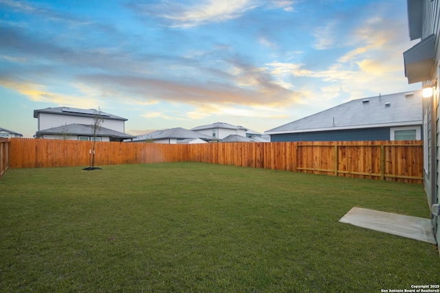 view of yard at dusk