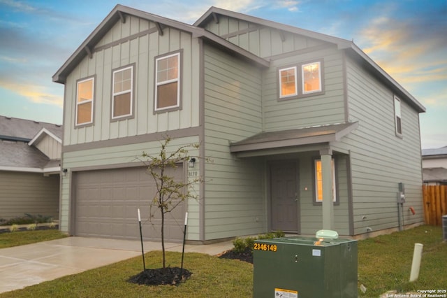 view of front of property with a garage and a lawn