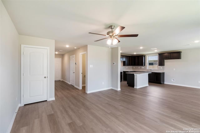 unfurnished living room with ceiling fan and light hardwood / wood-style flooring