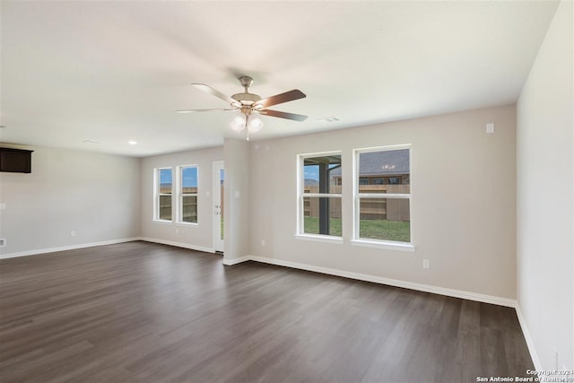 unfurnished room featuring ceiling fan and dark hardwood / wood-style flooring