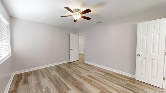 unfurnished bedroom with ceiling fan and light wood-type flooring