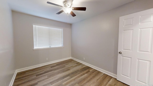 spare room with hardwood / wood-style flooring and ceiling fan