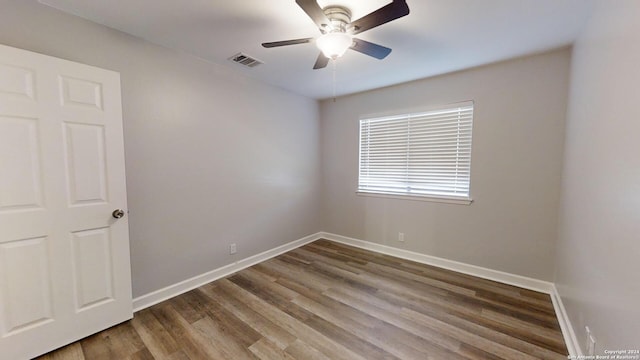 unfurnished room featuring hardwood / wood-style floors and ceiling fan