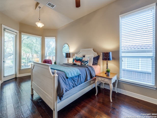 bedroom with dark hardwood / wood-style floors, vaulted ceiling, and ceiling fan