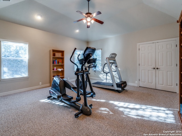 exercise area featuring lofted ceiling, light colored carpet, and ceiling fan