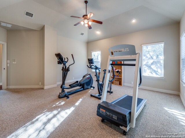 workout area featuring ceiling fan, carpet flooring, and lofted ceiling